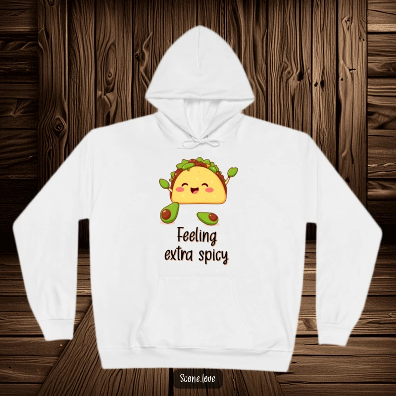 Funny hoodie featuring a happy taco juggling tiny avocados with its shell, offering warmth and a fiesta of humor.