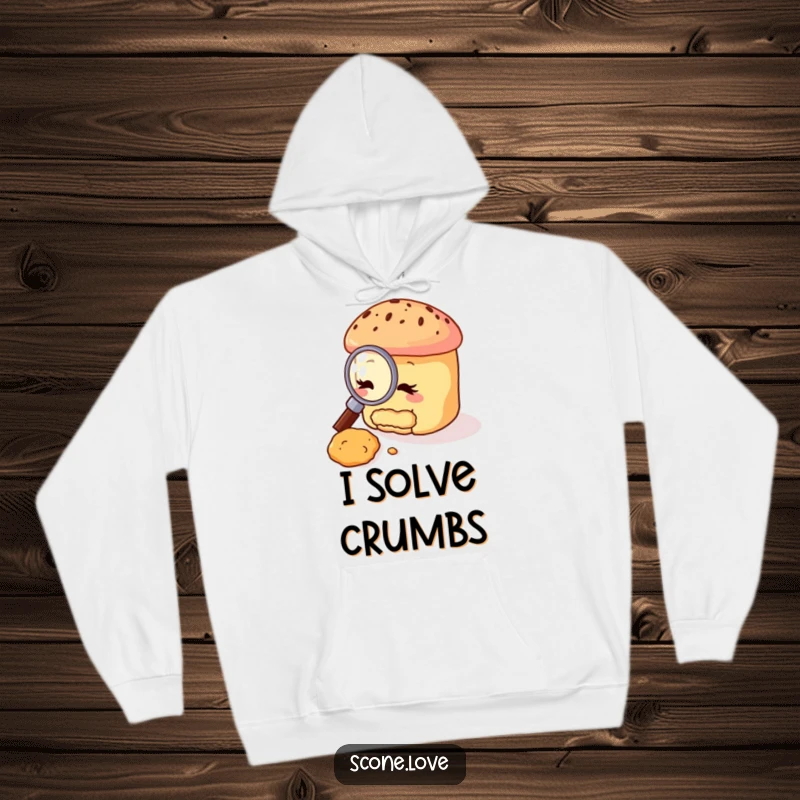 Funny scone hoodie featuring a scone character with a magnifying glass, meticulously examining a tiny crumb, highlighting a humorous foodie investigation.