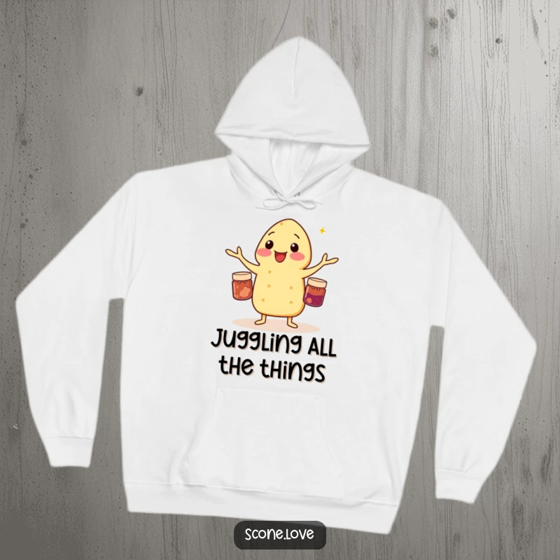 Funny hoodie featuring a scone masterfully juggling three tiny jam jars, a comical display of pastry skills.